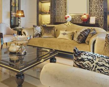 Luxurious living room with beige sofa, decorative pillows, and a coffee table.